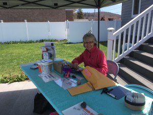 Smiling volunteer staffs the event table